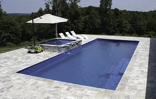 Leisure Pools The Grand rectangular fiberglass composite pool for lounging, installed by Leisure Pools Savannah