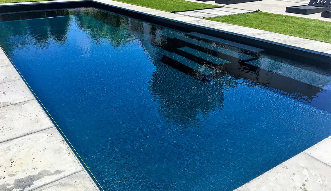 The Grand rectangular fiberglass pool with great side entry steps from Leisure Pools Savannah